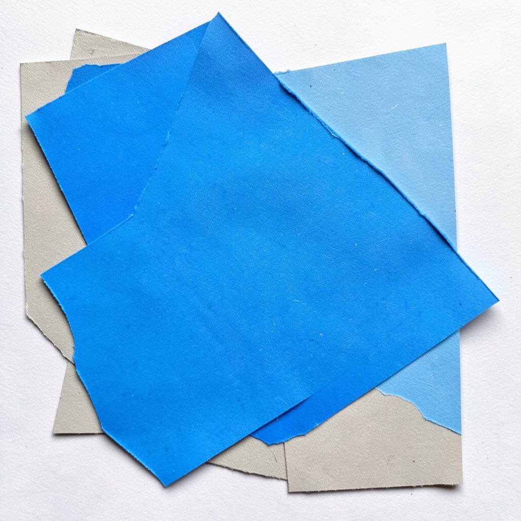 Layered paper cut-out collage of deep blue and teal geometric shapes overlapping in a dynamic, energetic composition